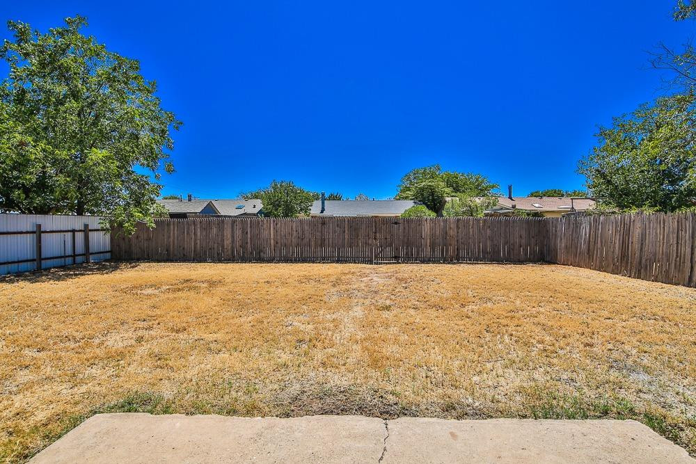 5503 1st Place Lubbock, TX 79416 - Photo 26 of 27 a view of a backyard with a large tree