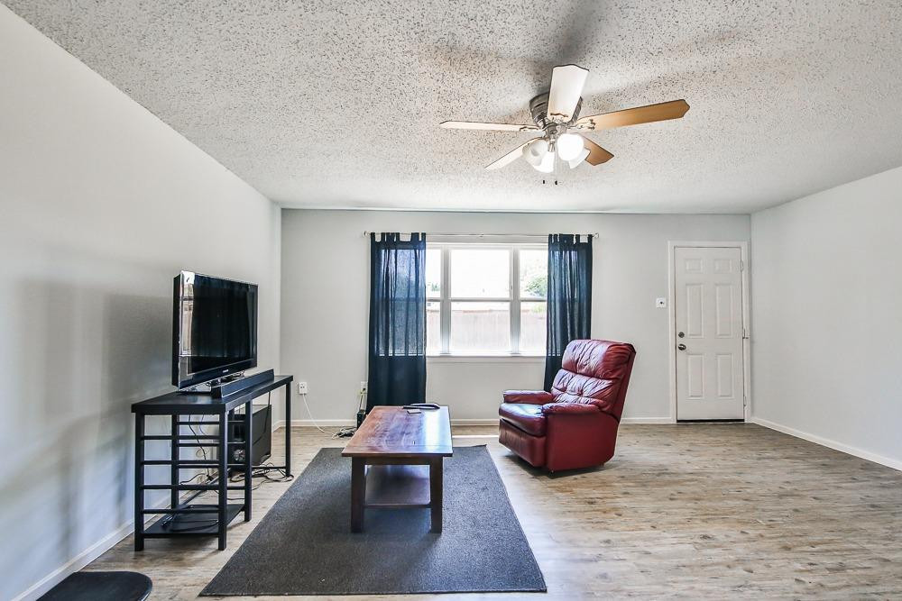 5503 1st Place Lubbock, TX 79416 - Photo 4 of 27 a living room with furniture and a flat screen tv