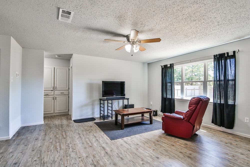 5503 1st Place Lubbock, TX 79416 - Photo 5 of 27 a living room with furniture and a flat screen tv