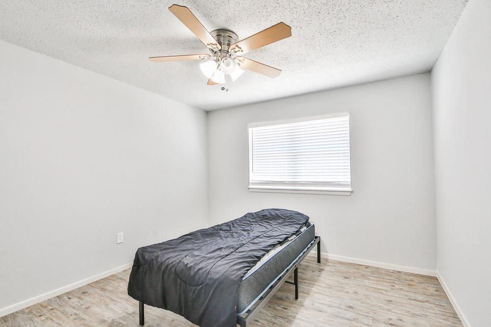 5503 1st Place Lubbock, TX 79416 - Photo 10 of 27 a bedroom with a bed and a window