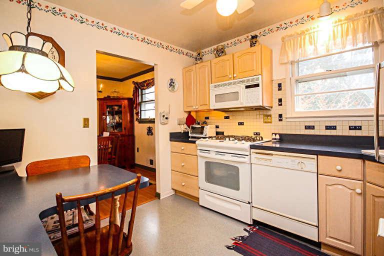 15311 Barnesville Road Boyds, MD 20841 - Photo 10 of 25 a kitchen with stainless steel appliances granite countertop a stove a sink and a refrigerator