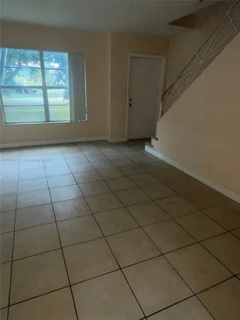 an empty room with a rug