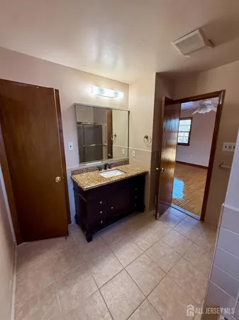 a bathroom with a double vanity sink and mirror