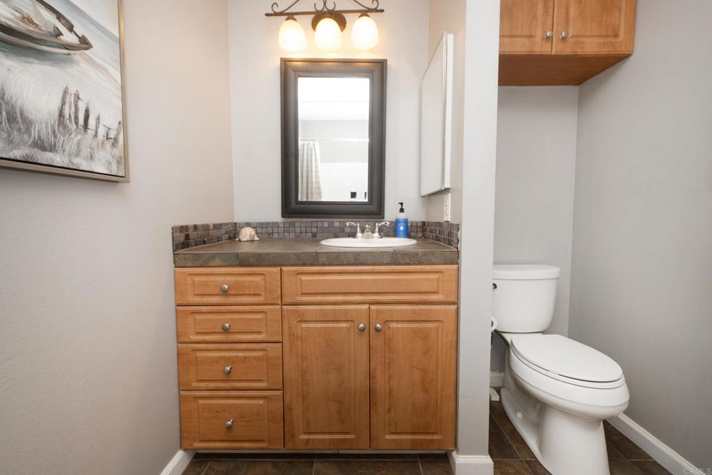 929 Jamacha Road, Unit B El Cajon, CA 92019 - Photo 26 of 36 a bathroom with a sink a toilet and mirror