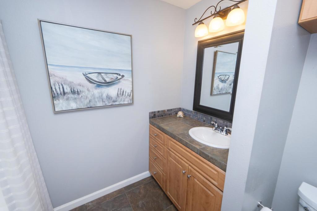 929 Jamacha Road, Unit B El Cajon, CA 92019 - Photo 29 of 36 a bathroom with a toilet sink vanity and mirror