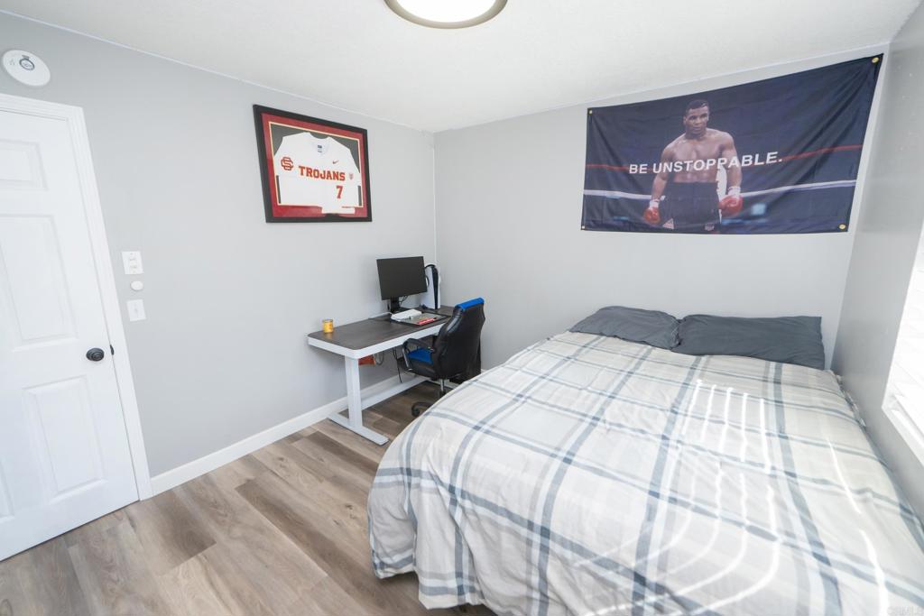 929 Jamacha Road, Unit B El Cajon, CA 92019 - Photo 32 of 36 a bedroom with a bed and a wall painting