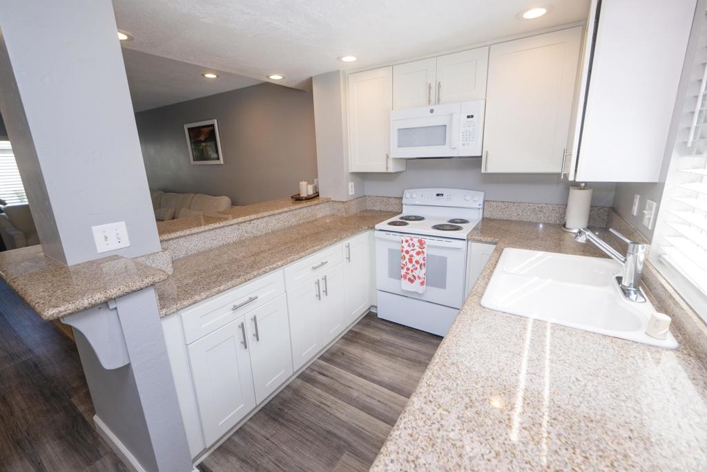 929 Jamacha Road, Unit B El Cajon, CA 92019 - Photo 10 of 36 a large kitchen with stainless steel appliances granite countertop a sink a stove and a granite counter top