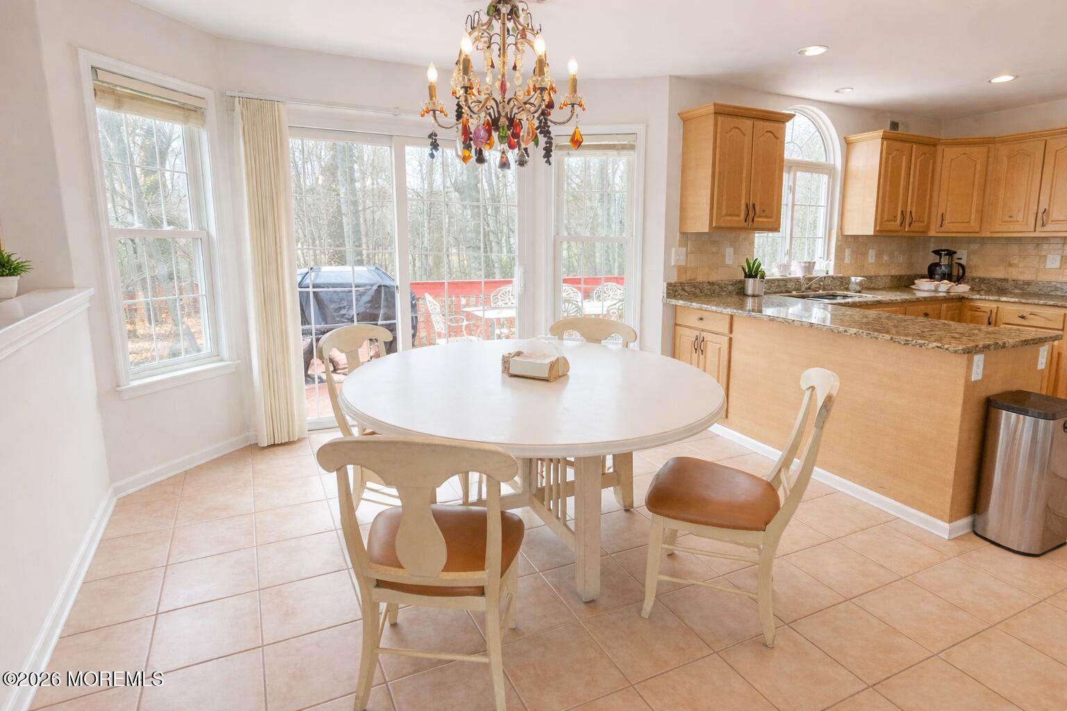405 Lawrence Avenue Oakhurst, NJ 07755 - Photo 3 of 23 a kitchen with a dining table and chairs