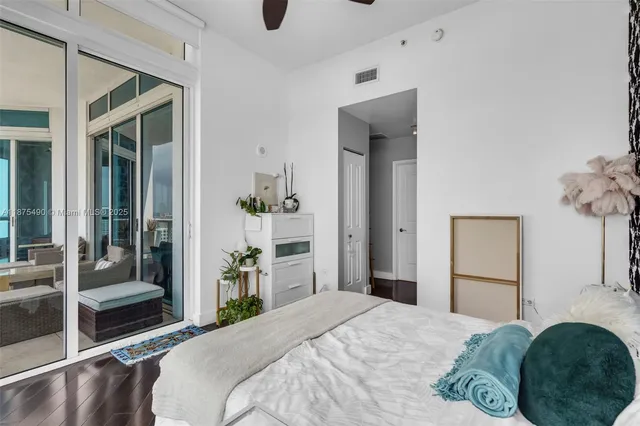 a bedroom with a bed and a mirror