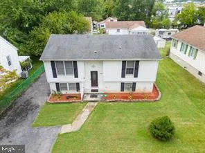 an aerial view of a house with a yard table and chairs