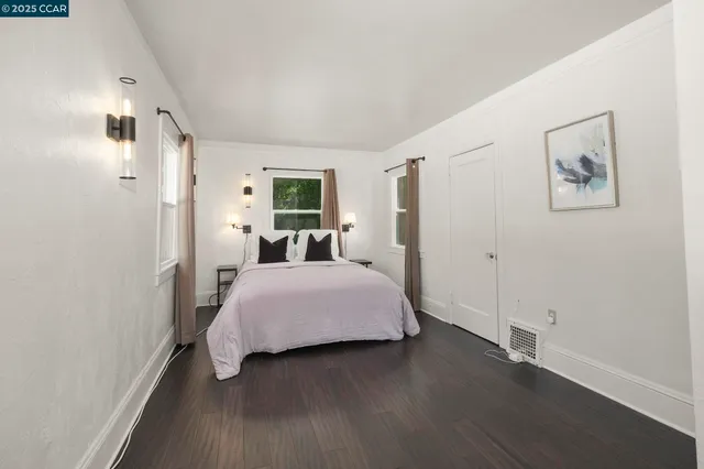 a bedroom with a large bed and a window