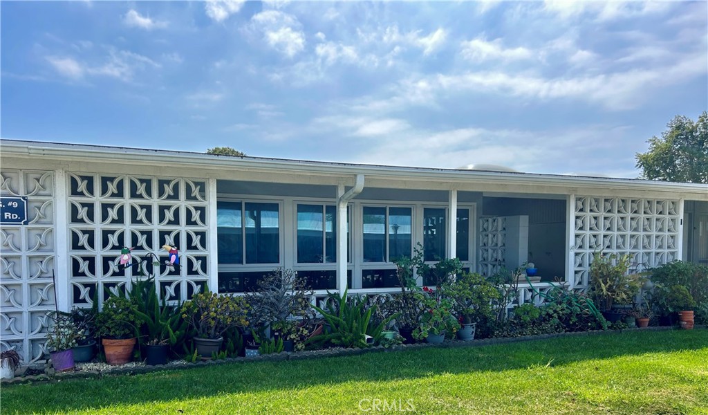 a view of a house with garden and yard