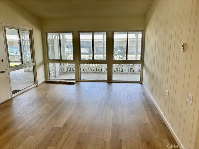a view of an entryway with wooden floor