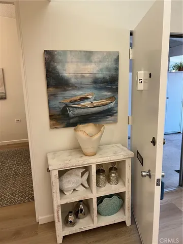 a living room with furniture a rug wooden floor and a floor to ceiling window