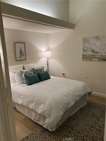 a bedroom with a bed and a lamp