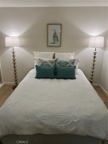 a bathroom with a granite countertop sink toilet and a mirror