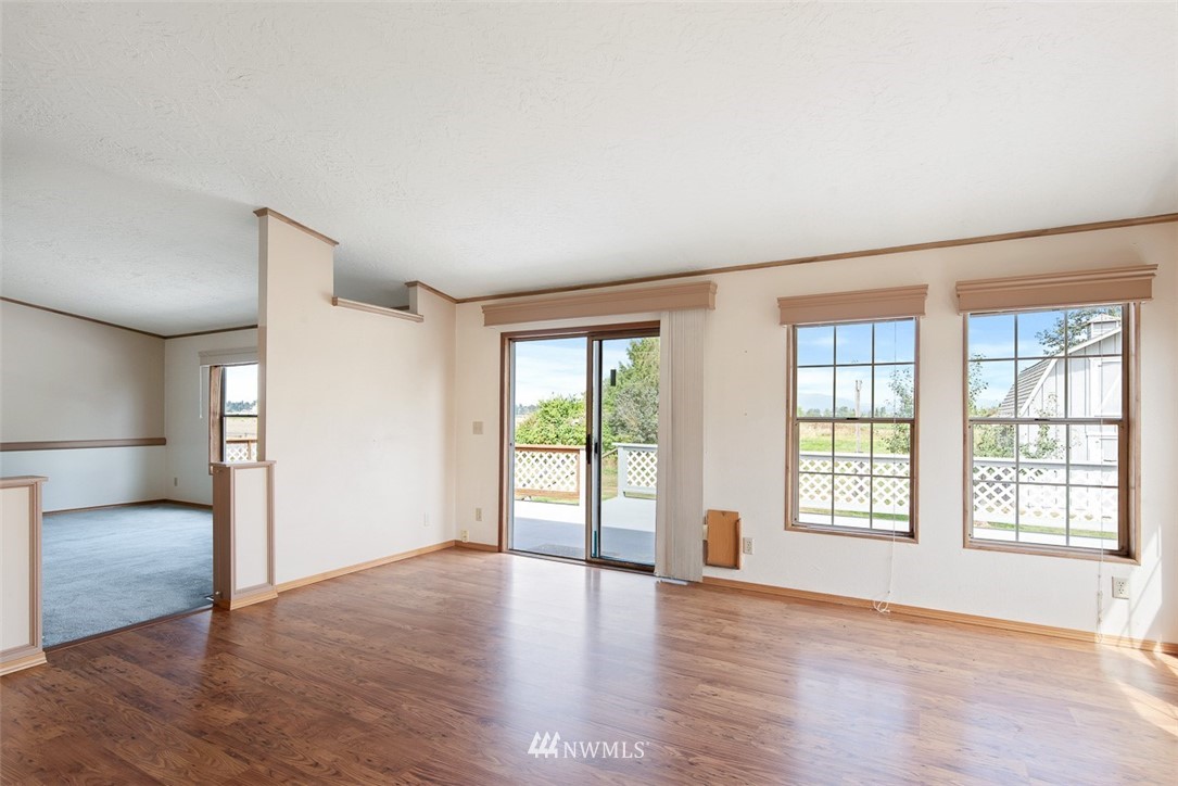 17855 Bennett Road Mount Vernon, WA 98273 - Photo 11 of 40 a view of an empty room with a window and wooden floor