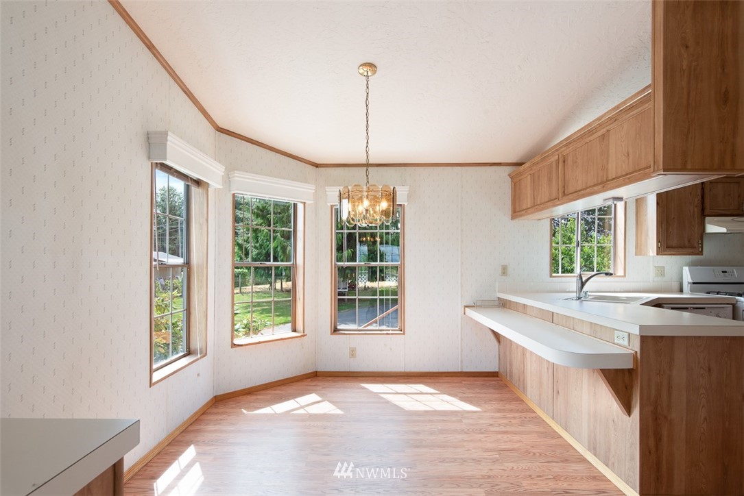 17855 Bennett Road Mount Vernon, WA 98273 - Photo 12 of 40 a kitchen with kitchen island granite countertop a stove a sink a center island and a window
