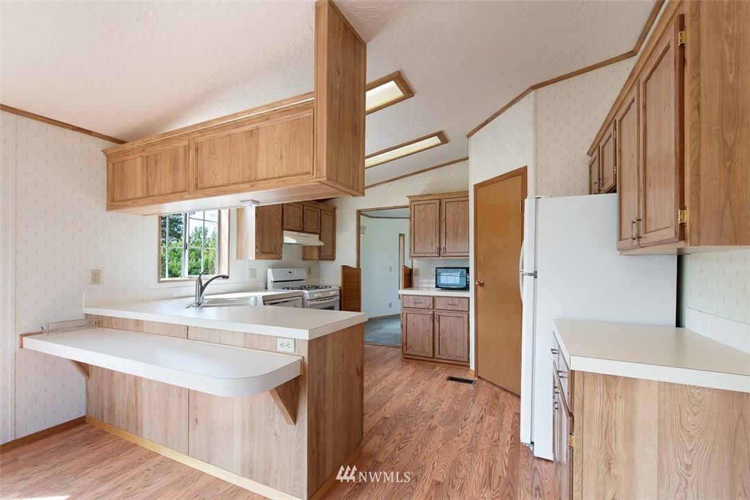 17855 Bennett Road Mount Vernon, WA 98273 - Photo 13 of 40 a kitchen with stainless steel appliances granite countertop a sink a stove and a refrigerator