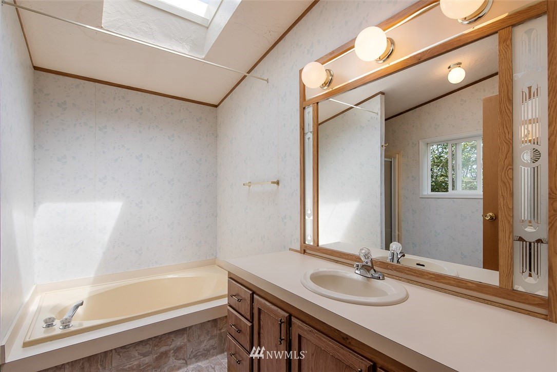 17855 Bennett Road Mount Vernon, WA 98273 - Photo 18 of 40 a bathroom with a granite countertop sink mirror toilet and bathtub