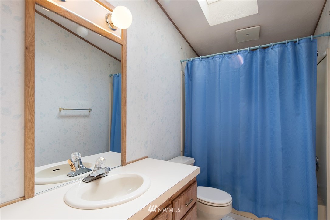 17855 Bennett Road Mount Vernon, WA 98273 - Photo 21 of 40 a bathroom with a sink a toilet and a mirror