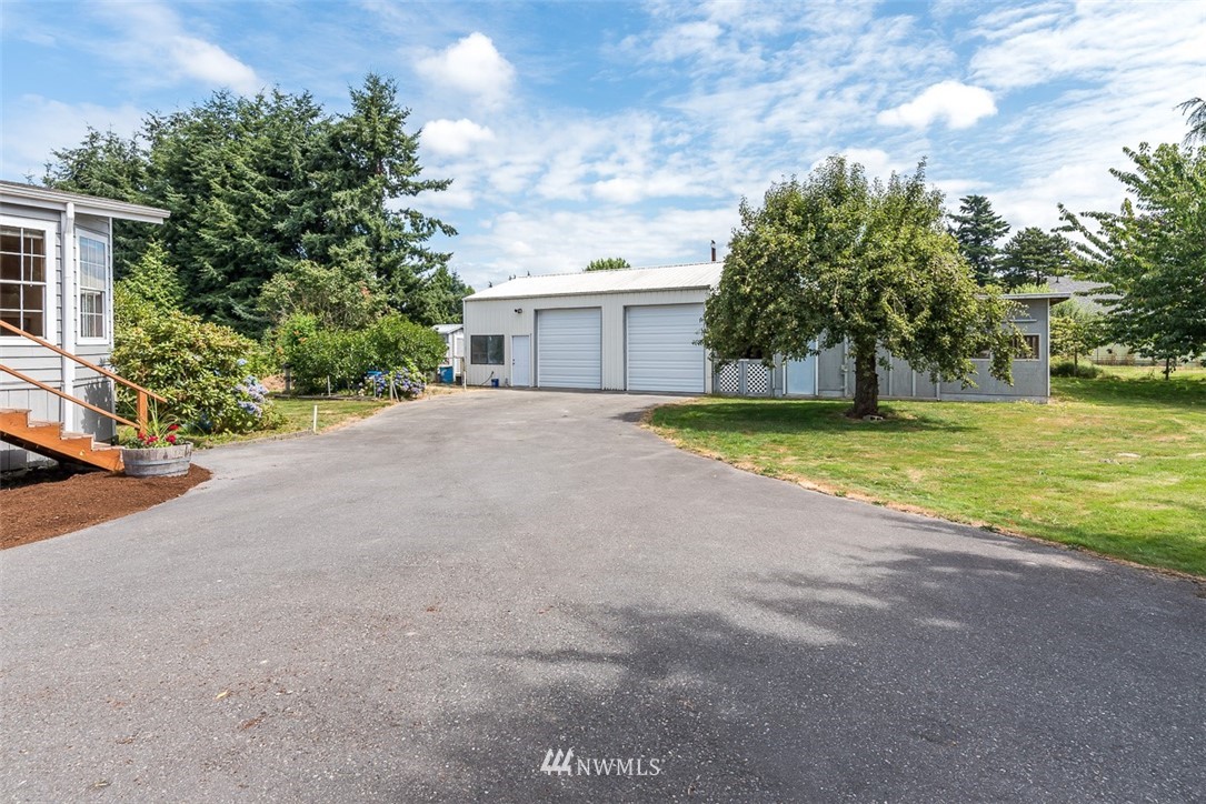17855 Bennett Road Mount Vernon, WA 98273 - Photo 25 of 40 a view of a house with a yard and a garage