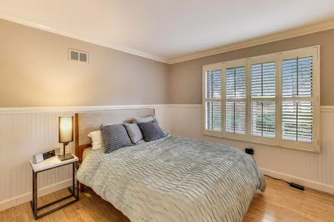 a bedroom with a bed and window