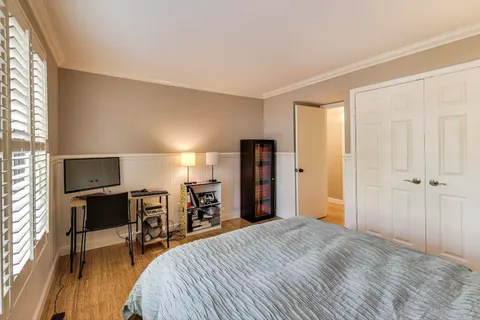 a bedroom with a bed and a table in it