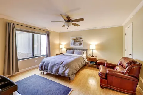 a bedroom with a bed couch and window