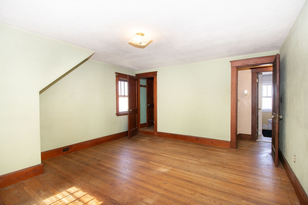 86 Westminster Road Weymouth, MA 02189 - Photo 5 of 15 a view of an empty room with wooden floor and a window