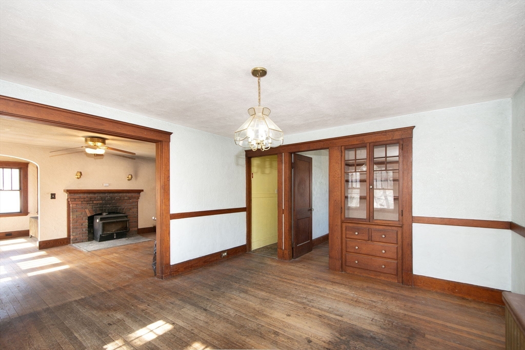 86 Westminster Road Weymouth, MA 02189 - Photo 9 of 15 wooden floor fireplace and windows in an empty room