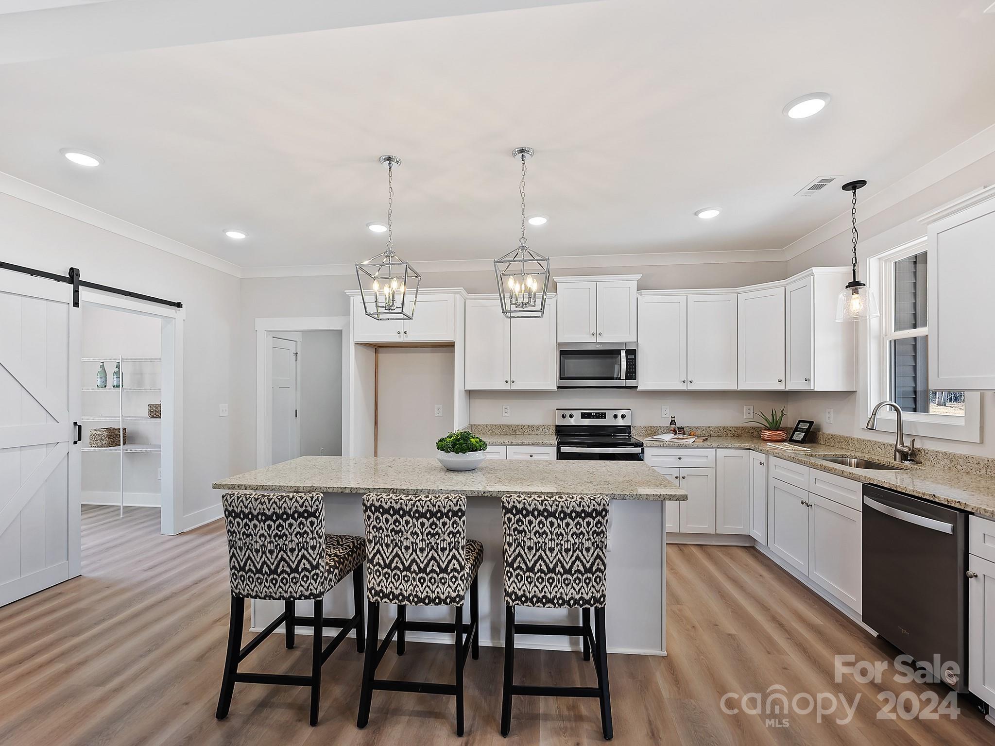 194 Old Pinckney Road York, SC 29745 - Photo 11 of 30 a kitchen with kitchen island granite countertop a sink and stainless steel appliances