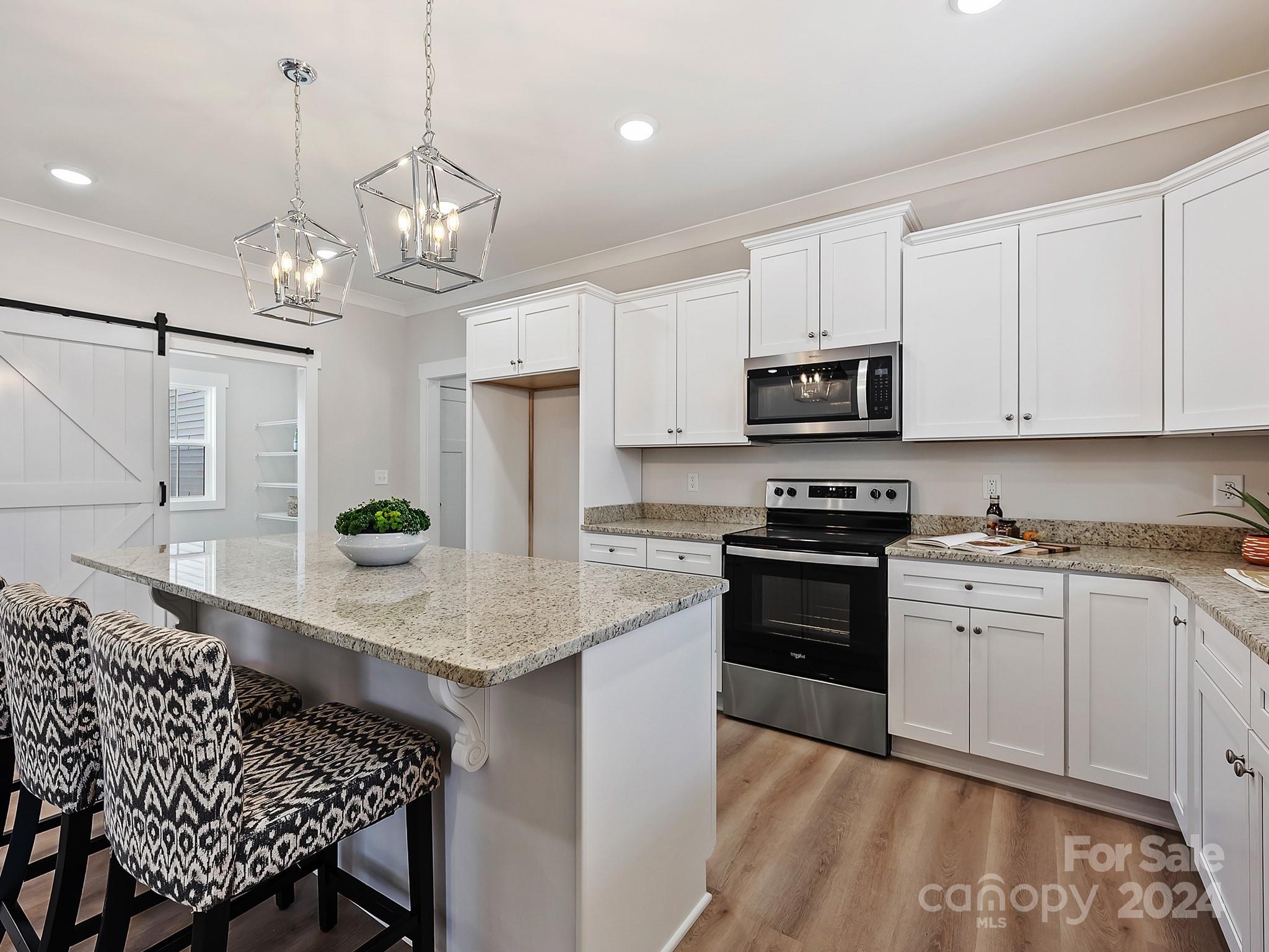194 Old Pinckney Road York, SC 29745 - Photo 12 of 30 a kitchen with kitchen island granite countertop stainless steel appliances a stove a sink and a refrigerator
