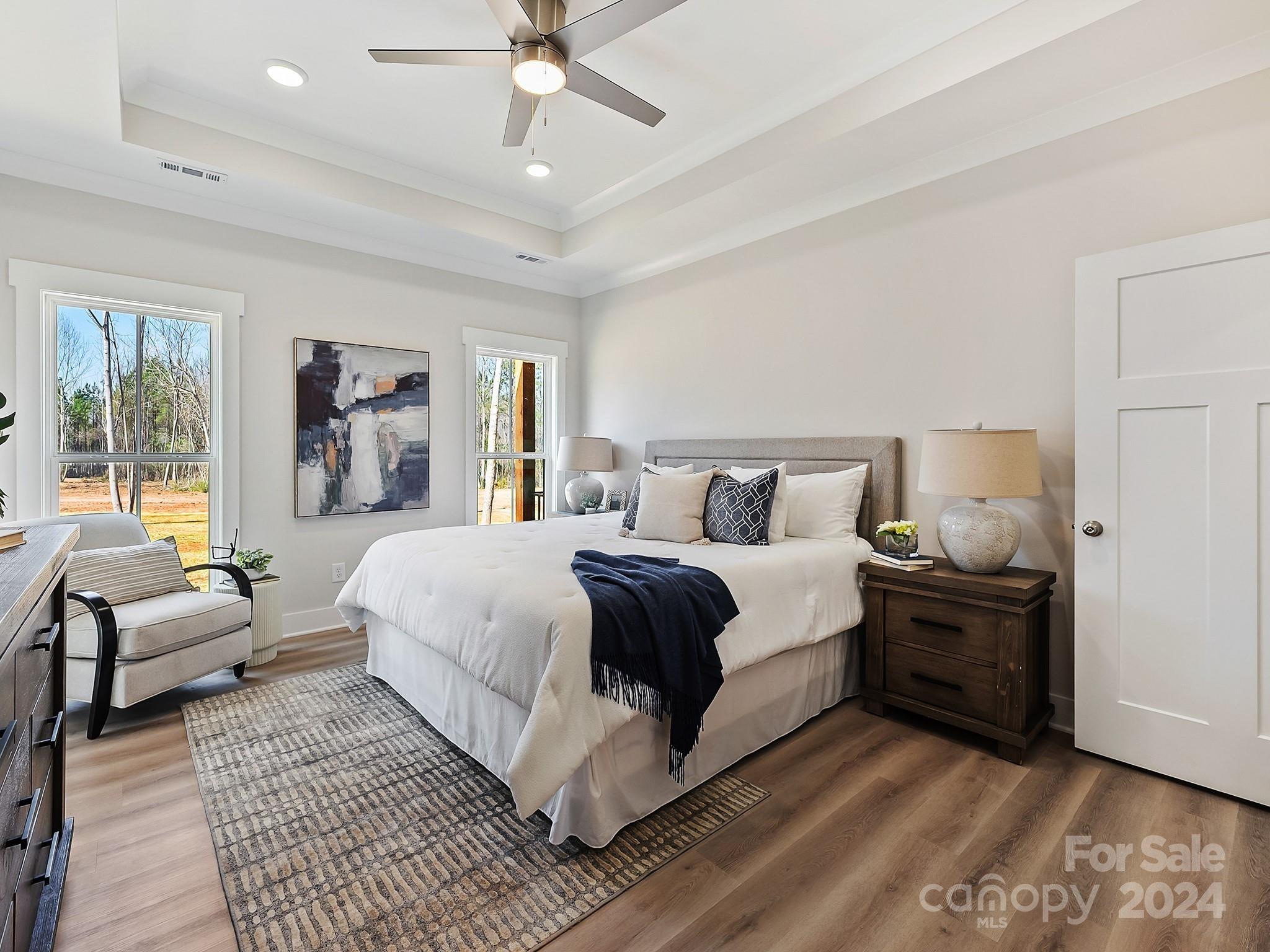 194 Old Pinckney Road York, SC 29745 - Photo 18 of 30 a bedroom with a large bed and a chandelier