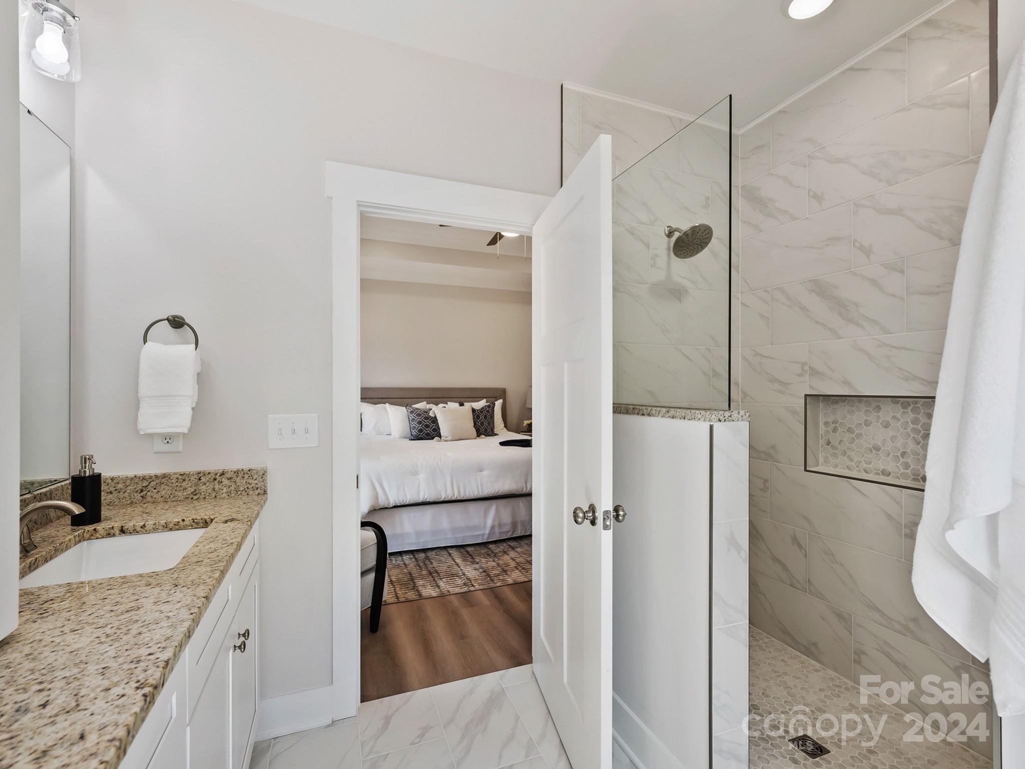 194 Old Pinckney Road York, SC 29745 - Photo 21 of 30 a bathroom with a granite countertop sink a mirror and shower