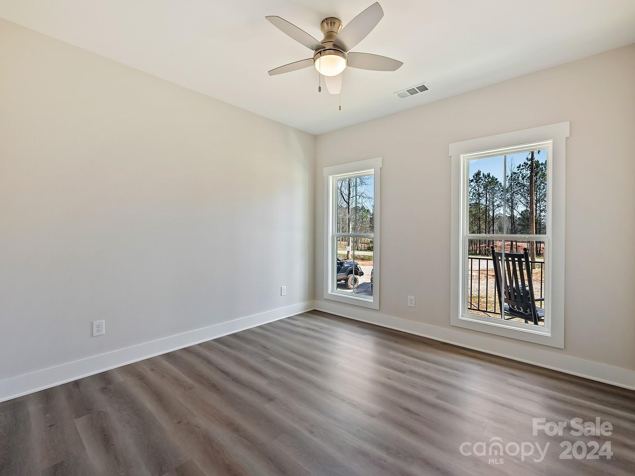 194 Old Pinckney Road York, SC 29745 - Photo 24 of 30 a view of an empty room with a window and wooden floor