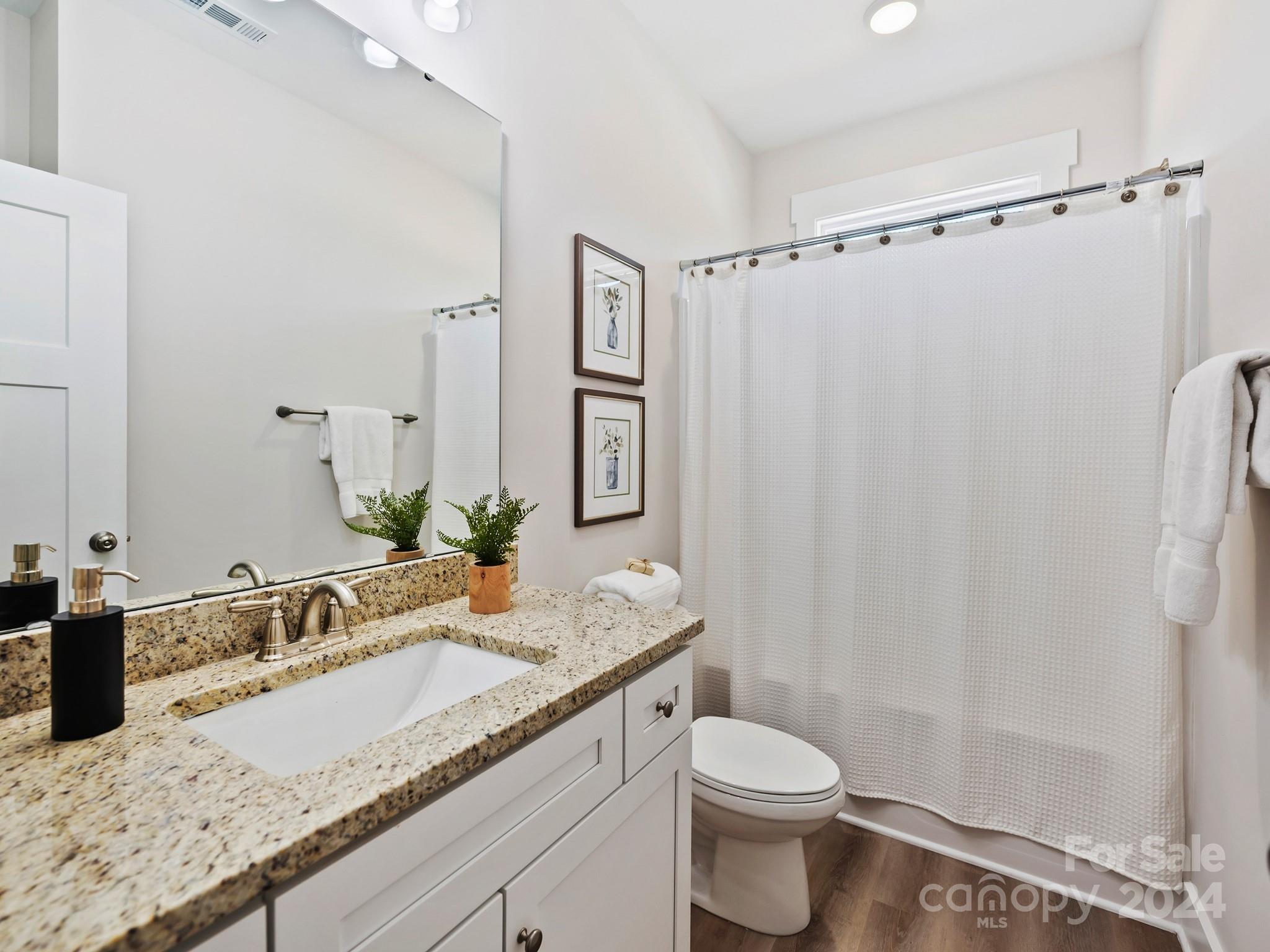 194 Old Pinckney Road York, SC 29745 - Photo 25 of 30 a bathroom with a granite countertop sink toilet and shower