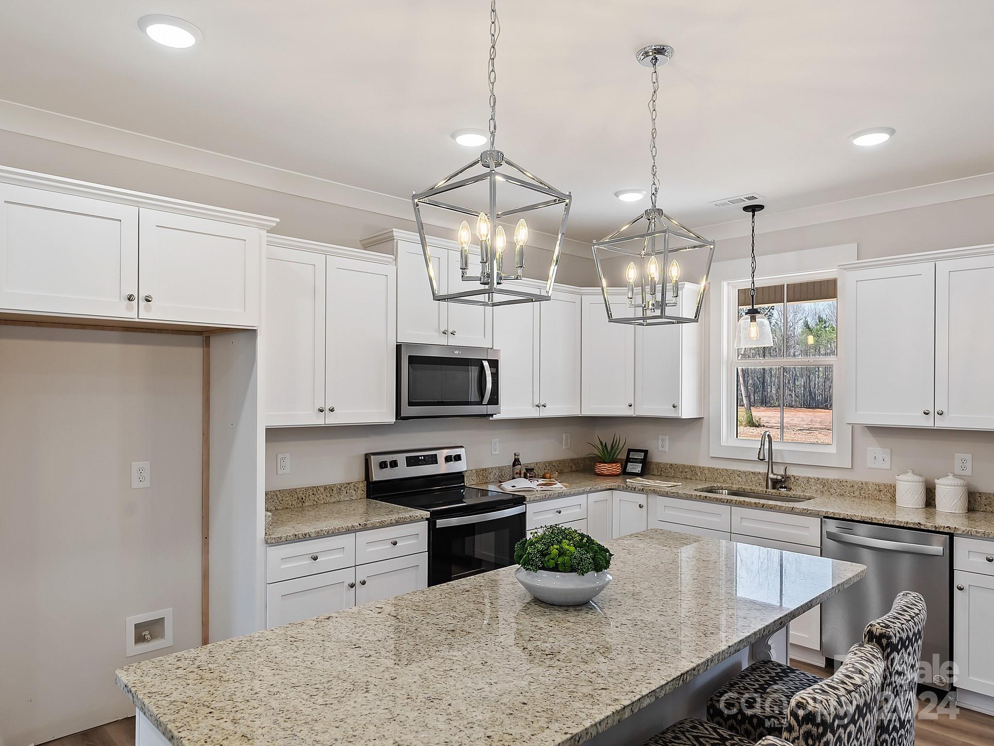 194 Old Pinckney Road York, SC 29745 - Photo 10 of 30 a kitchen with stainless steel appliances granite countertop a sink a stove a refrigerator a center island a stove and cabinets