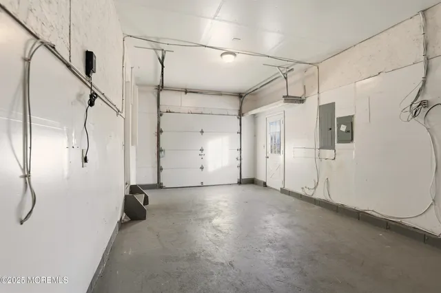 a view of a room with stairs and a white door