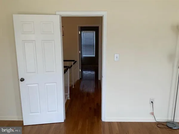 a view of hallway with wooden floor