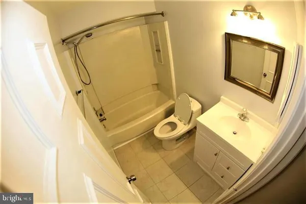 a bathroom with a sink mirror and a shower