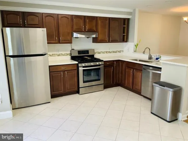 a kitchen with a refrigerator sink and stove