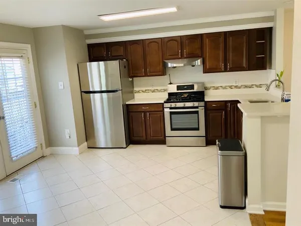 a kitchen with a refrigerator and a stove