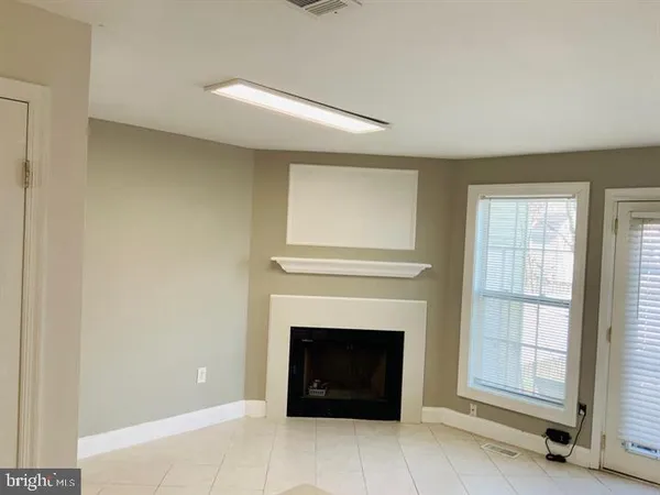 a living room with a fireplace and a window