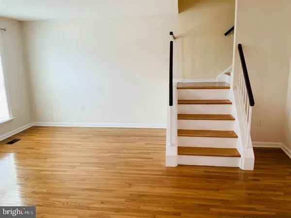 a view of a room with wooden floor