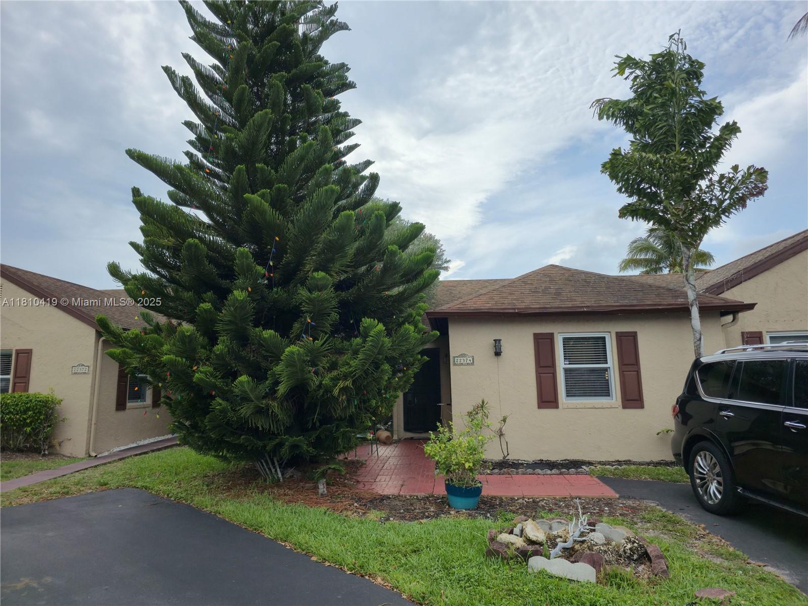 22374 Southwest 57th Circle Boca Raton, FL 33428 - Photo 1 of 31 a front view of a house with garden