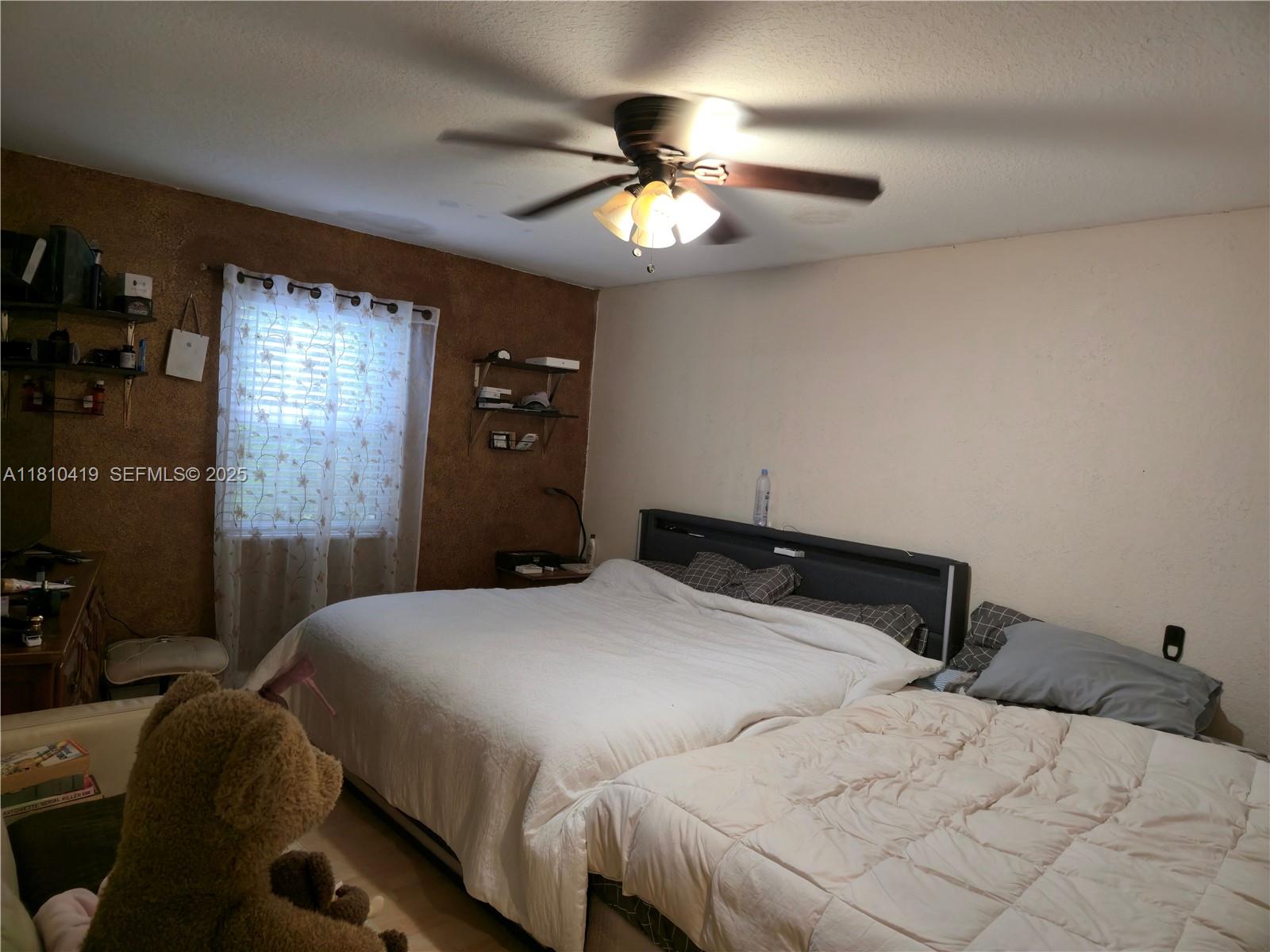 22374 Southwest 57th Circle Boca Raton, FL 33428 - Photo 11 of 31 a bedroom with a bed and a chandelier