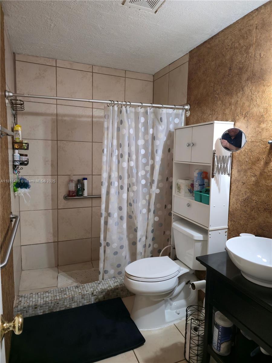 22374 Southwest 57th Circle Boca Raton, FL 33428 - Photo 14 of 31 a bathroom with a toilet and a shower