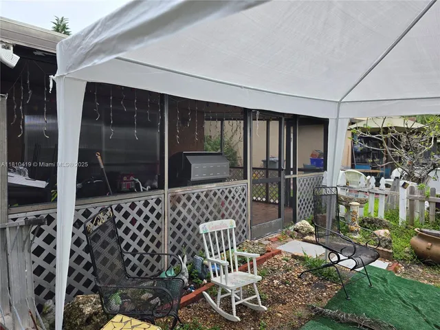 a balcony with table and chairs