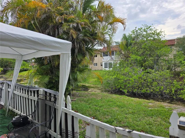 a view of a porch and garden